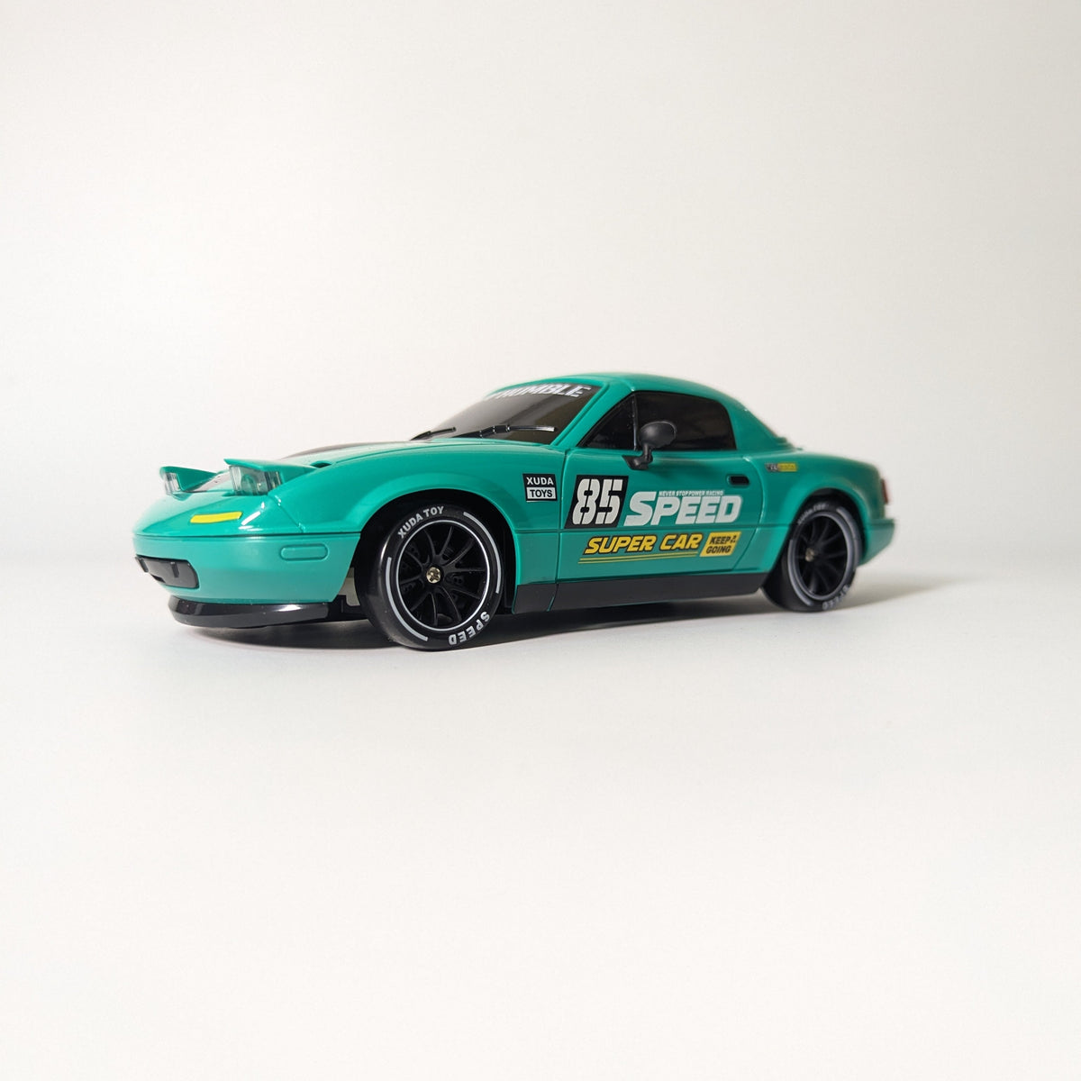 A teal and black toy model car with '85 SPEED Super Car' decals, shown on a plain light gray studio background.