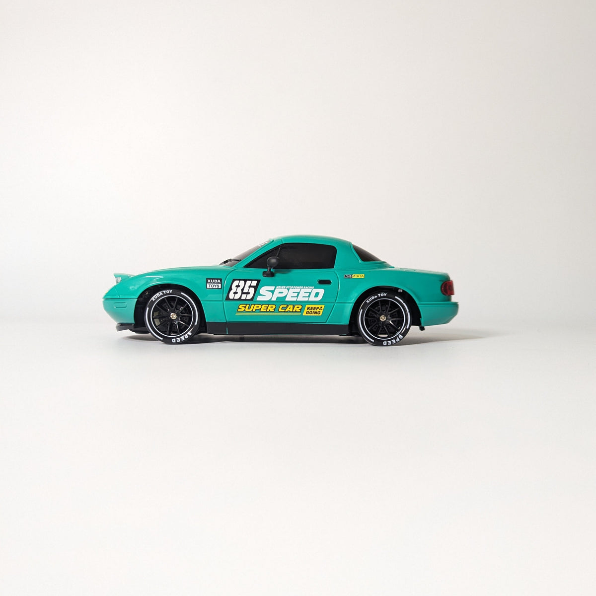 A blue diecast model car with racing decals, including 'SPEED 65' and 'DUNN CAR', displayed on a clean white studio background.