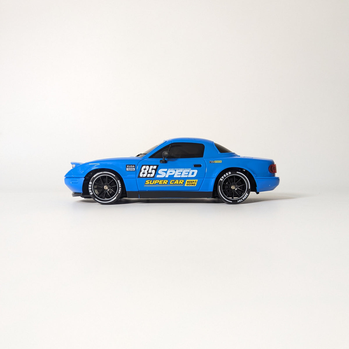 A blue toy model car with '95 SPEED' and 'SUPER SLEEK' decals, shown in profile against a plain light gray background.