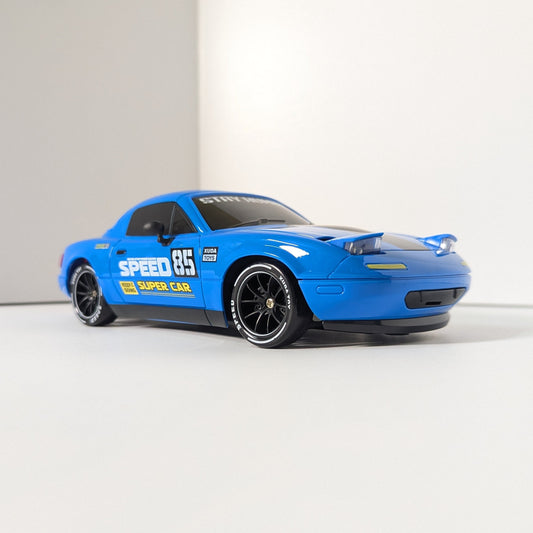 A blue diecast model car with racing decals, including 'SPEED 65' and 'DUNN CAR', displayed on a clean white studio background.