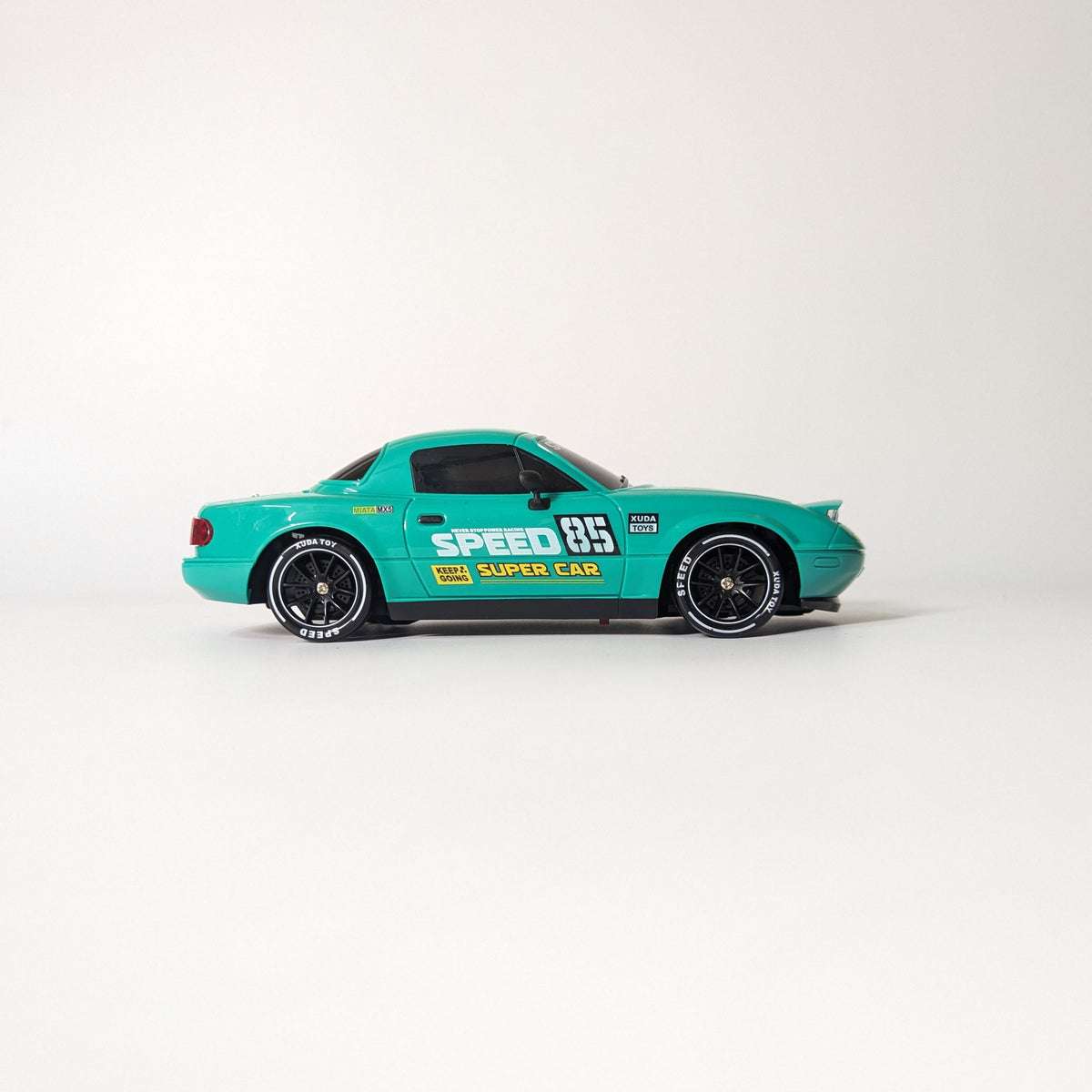 A green diecast model car with racing decals, including 'SPEED 65' and 'DUNN CAR', displayed on a clean white studio background.