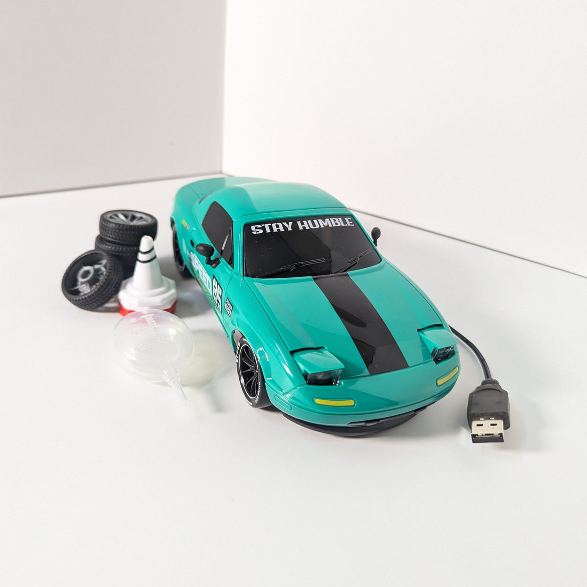 A green die-cast model car with racing decals, including 'SPEED 85' and 'SUPER CAR', shown in profile against a plain white studio background.